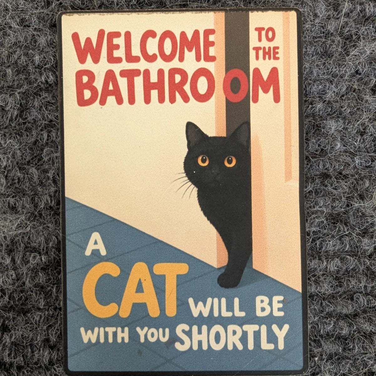 Feline Assistance magnet on a grey carpet [Feline Assistance (2×3 in)]