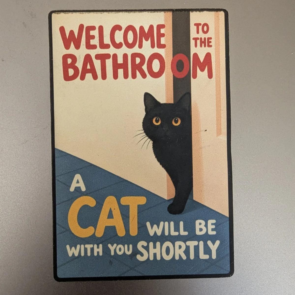 Feline Assistance magnet on a laptop lid [Feline Assistance (2×3 in)]